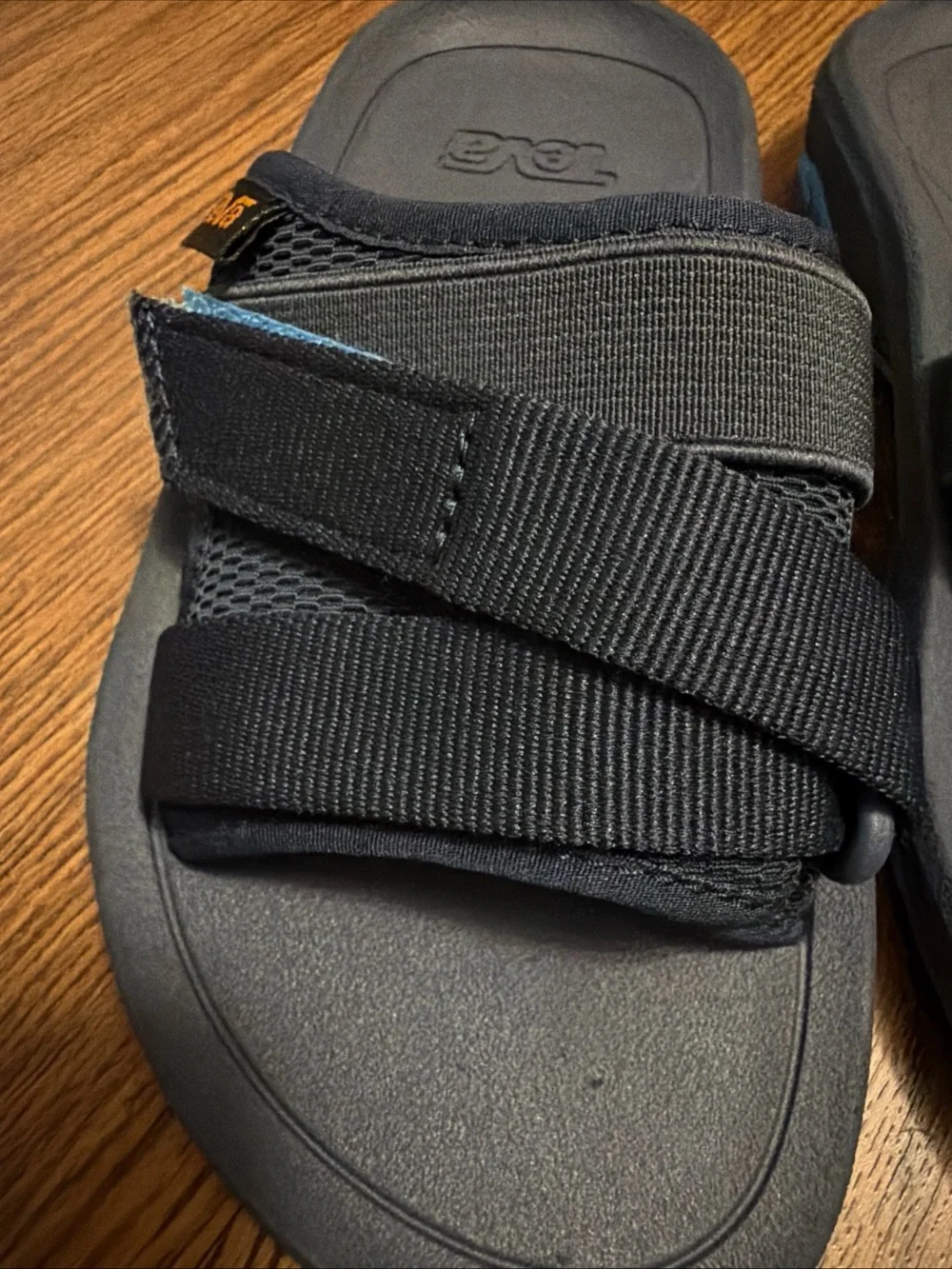 Teva Black Slide Sandals with Blue Accent